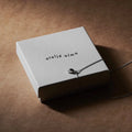 Silver lucky stone necklace on Ateljé Alma gift box