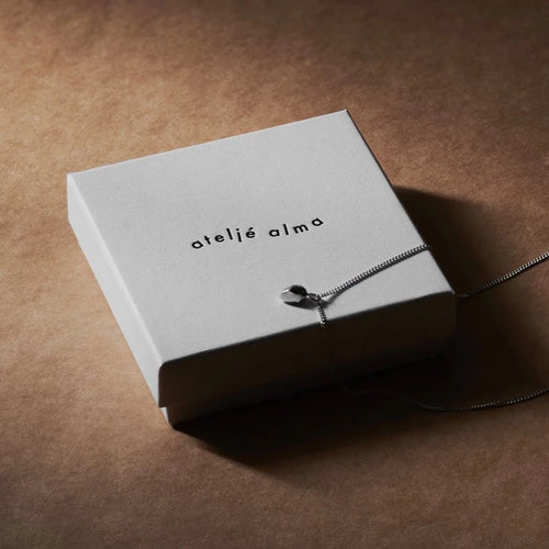 Silver lucky stone necklace on Ateljé Alma gift box